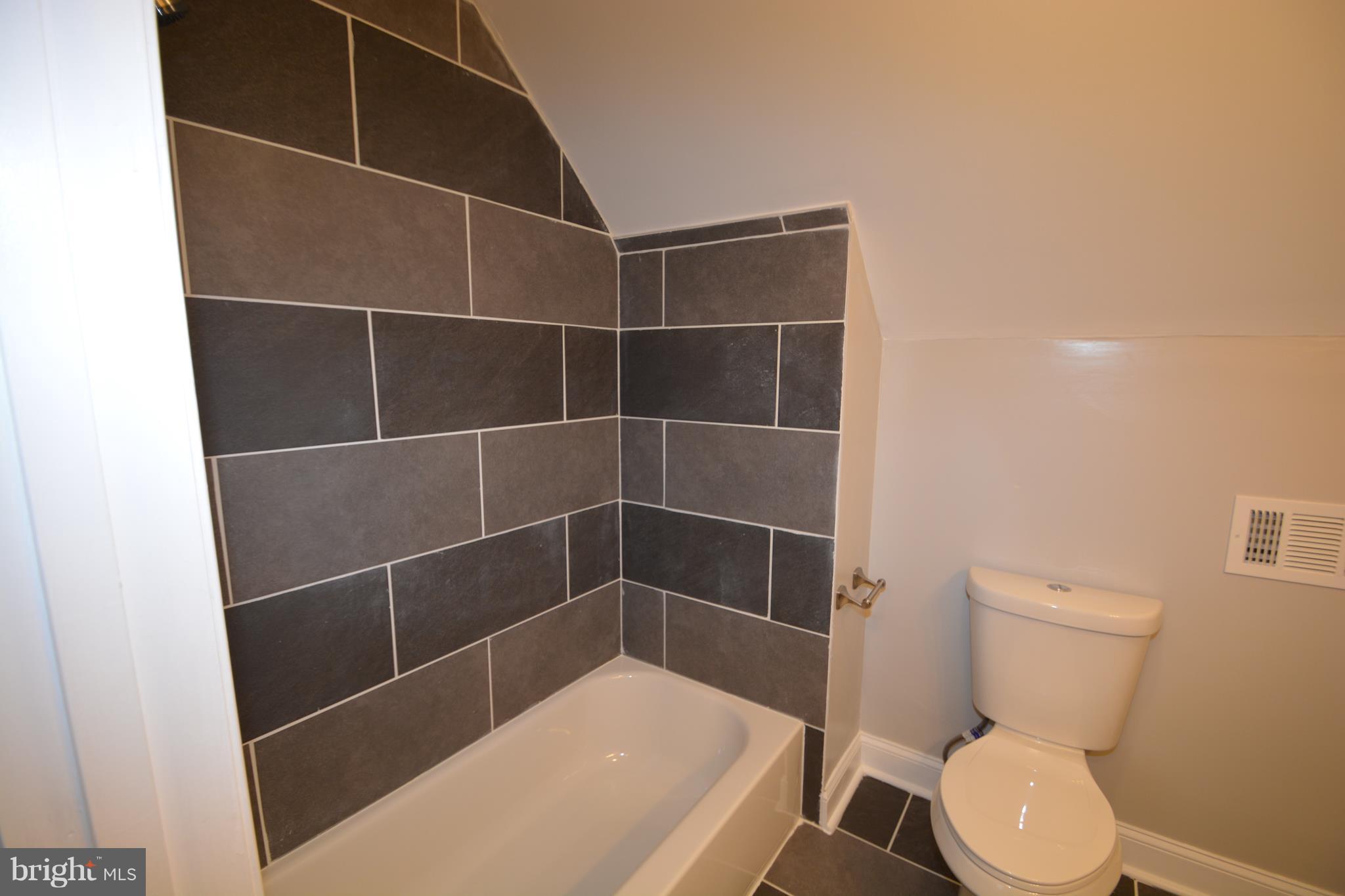 7116 Marston Road Baltimore, MD 21207 - Photo 17 of 30 a bathroom with a toilet and a shower