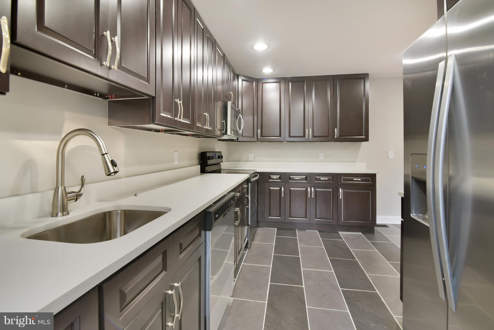 7116 Marston Road Baltimore, MD 21207 - Photo 19 of 30 a kitchen with a sink cabinets and stainless steel appliances