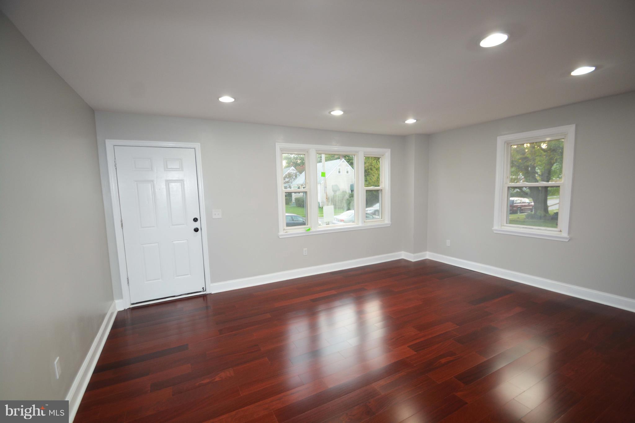 7116 Marston Road Baltimore, MD 21207 - Photo 3 of 30 a view of an empty room with wooden floor and a window