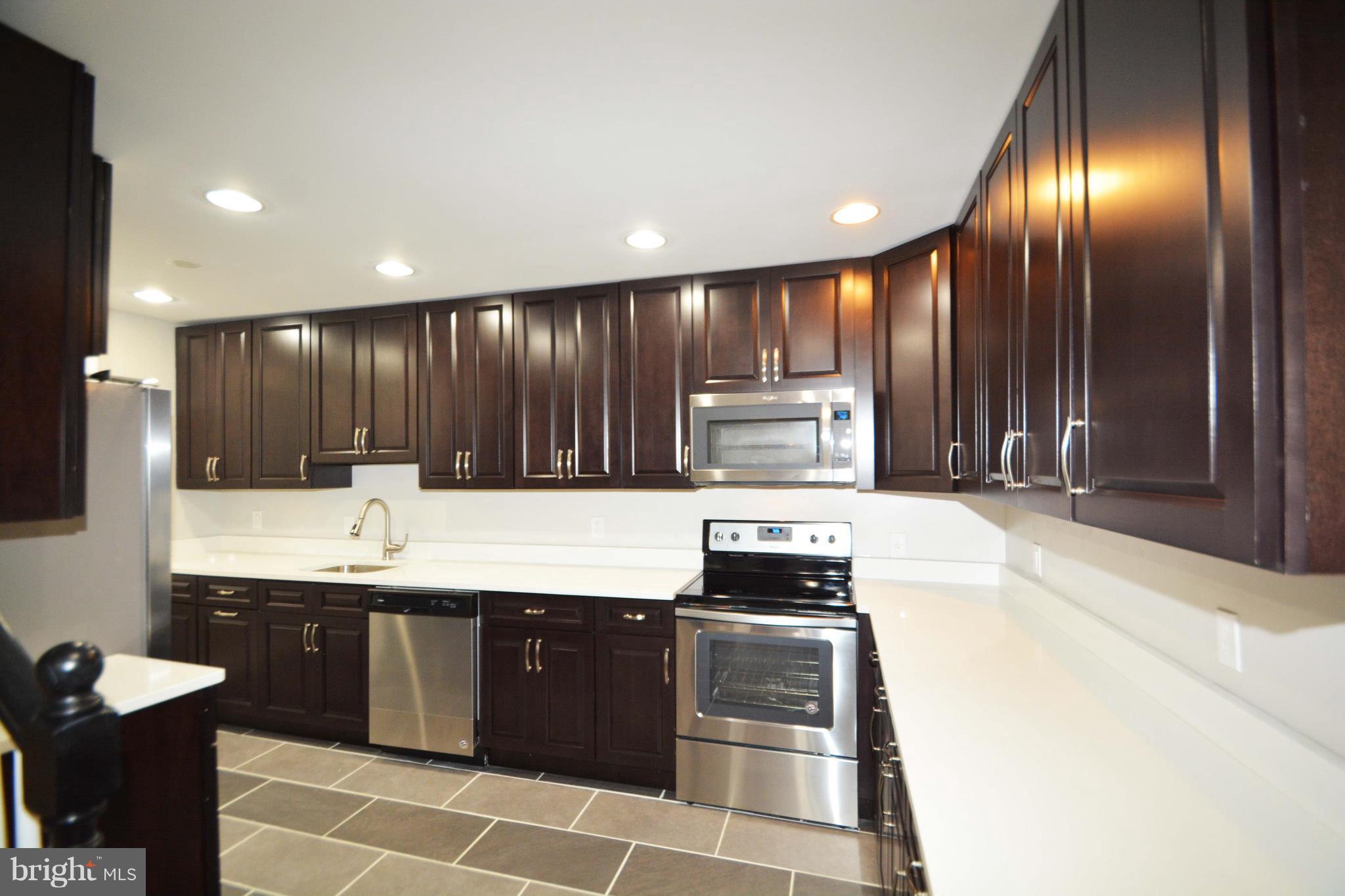 7116 Marston Road Baltimore, MD 21207 - Photo 21 of 30 a large kitchen with stainless steel appliances a large counter top