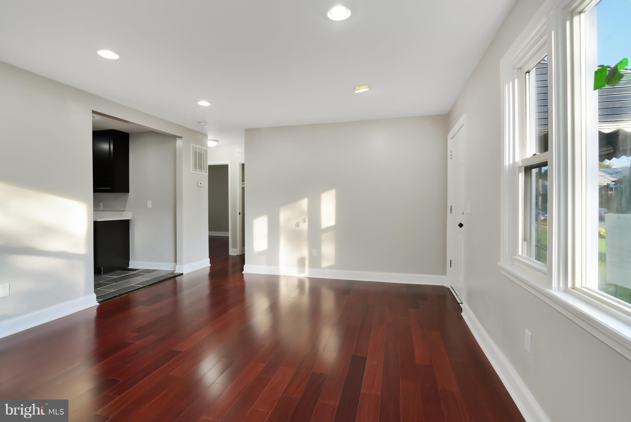 7116 Marston Road Baltimore, MD 21207 - Photo 22 of 30 a view of an empty room with wooden floor and a window