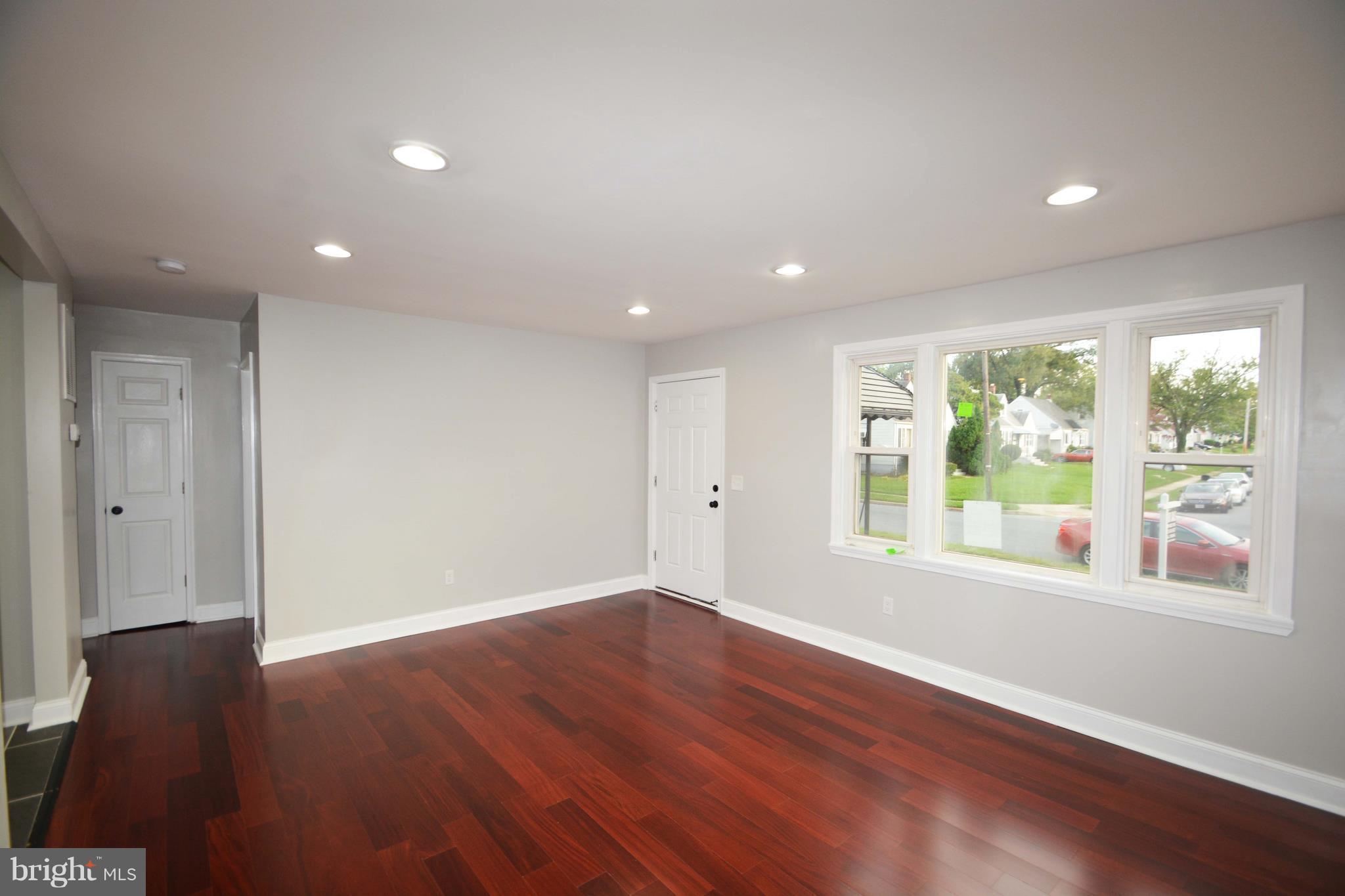 7116 Marston Road Baltimore, MD 21207 - Photo 5 of 30 a view of empty room with wooden floor and fan