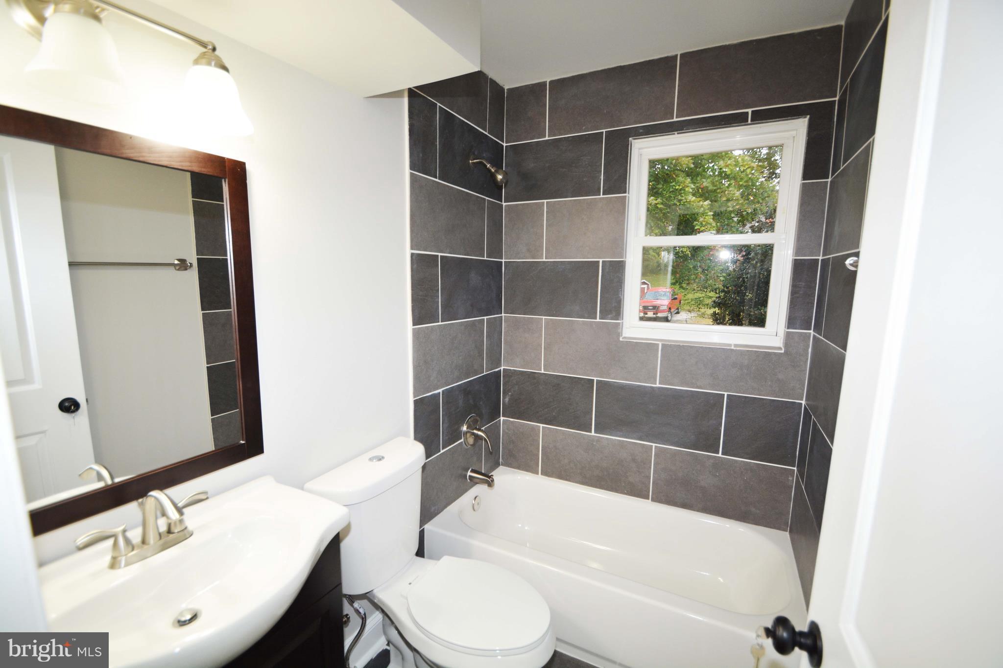 7116 Marston Road Baltimore, MD 21207 - Photo 9 of 30 a bathroom with a sink toilet and shower