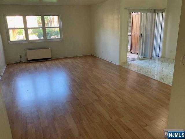 1111 River Road, Unit F2 Edgewater, NJ 07020 - Photo 10 of 21 an empty room with wooden floor and windows