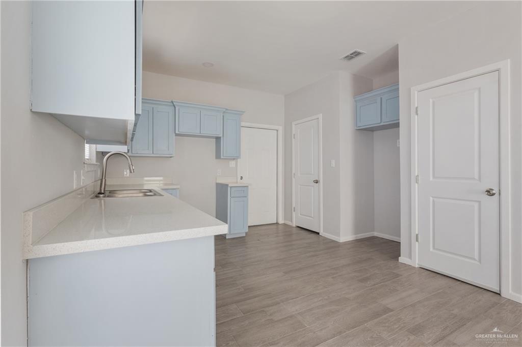 340 Eva Street, Unit 3 Edcouch, TX 78538 - Photo 5 of 12 a kitchen with a sink and a refrigerator