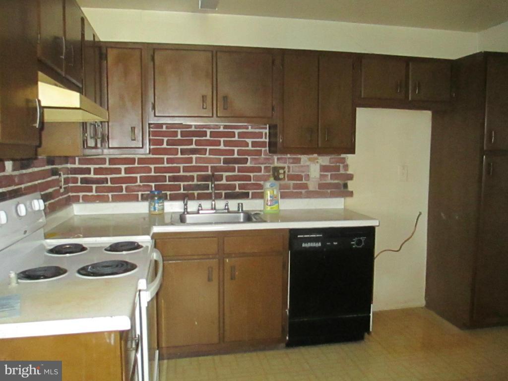 400 Laburnum Road Edgewood, MD 21040 - Photo 4 of 23 a kitchen with a sink a stove and refrigerator