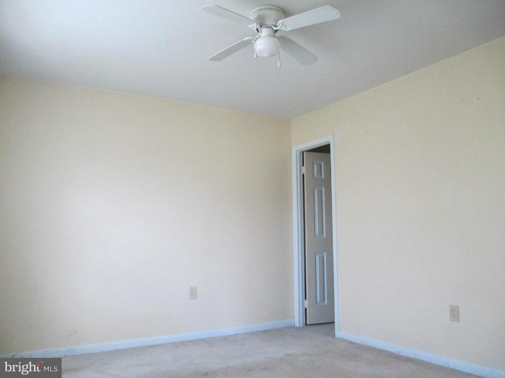 400 Laburnum Road Edgewood, MD 21040 - Photo 8 of 23 an empty room with a ceiling fan and carpet