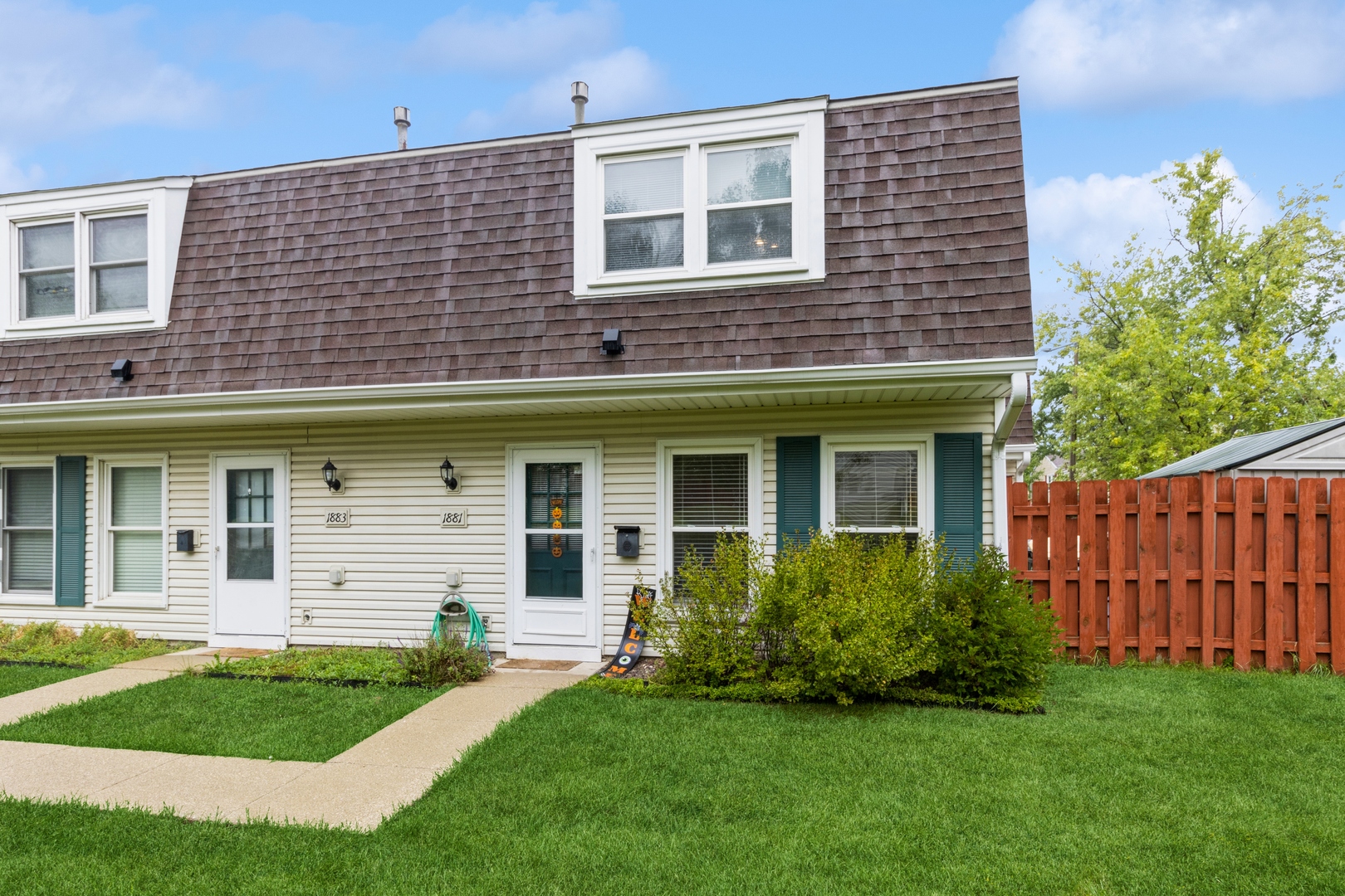 1881 Jamestown Circle Hoffman Estates, IL 60169 - Photo 2 of 11 a front view of a house with a garden
