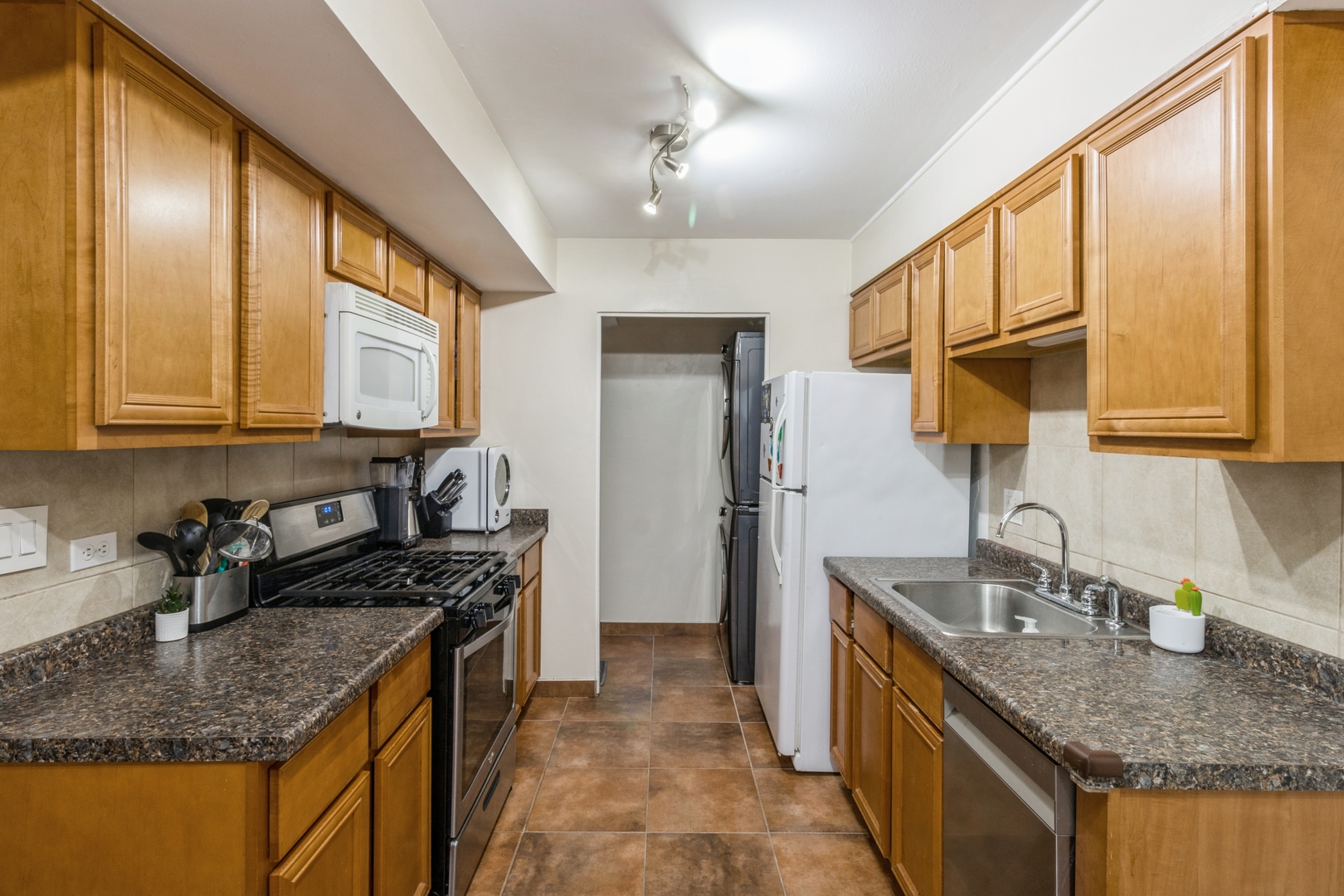 1881 Jamestown Circle Hoffman Estates, IL 60169 - Photo 5 of 11 a kitchen with stainless steel appliances granite countertop a sink a stove and a wooden cabinets