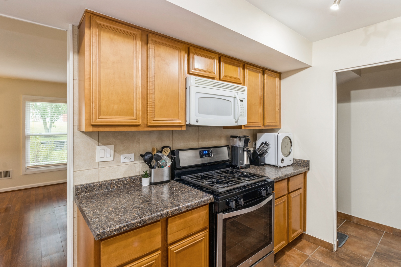 1881 Jamestown Circle Hoffman Estates, IL 60169 - Photo 6 of 11 a kitchen with stainless steel appliances granite countertop white cabinets and a stove top oven