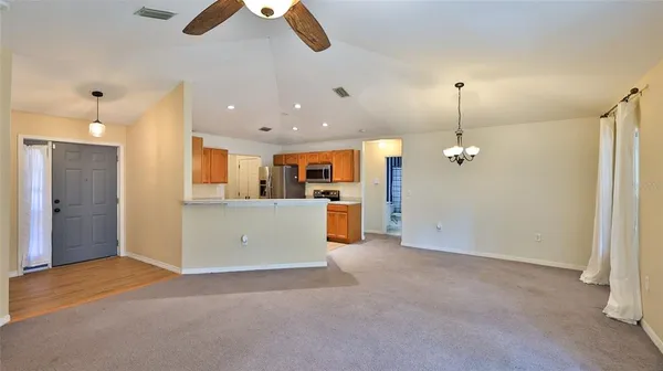 a view of a kitchen with a refrigerator and a ceiling fan