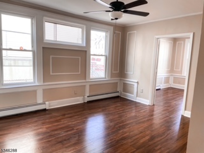596 South 19th Street Newark, NJ 07103 - Photo 3 of 9 wooden floor in an empty room with a window