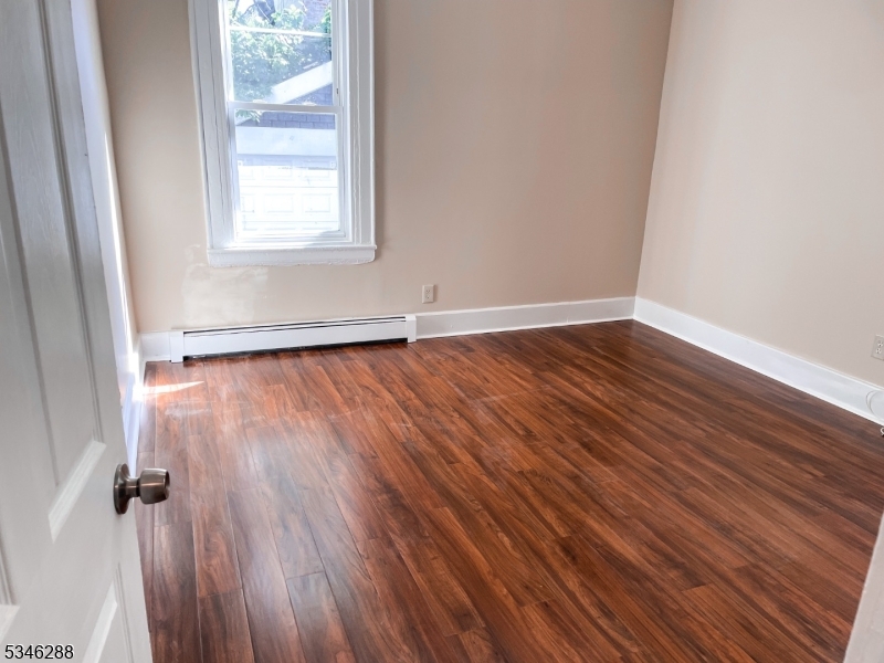 596 South 19th Street Newark, NJ 07103 - Photo 9 of 9 an empty room with wooden floor and windows