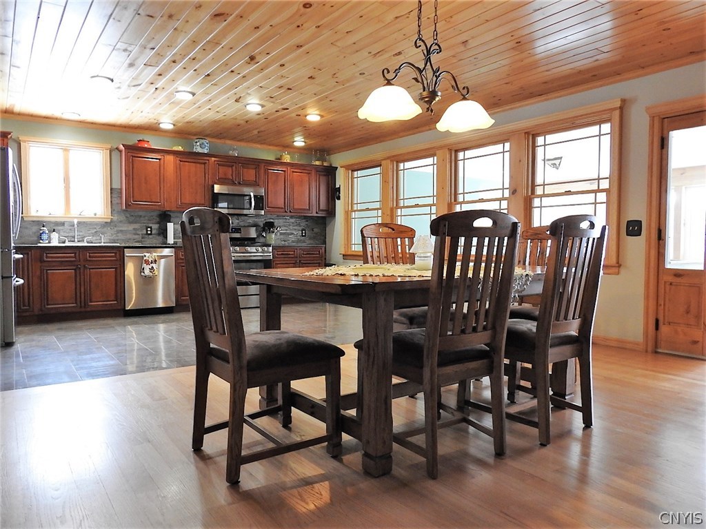 5771 Long Point Road Brantingham, NY 13312 - Photo 5 of 49 Open Dining / Kitchen area. Propane fireplace just