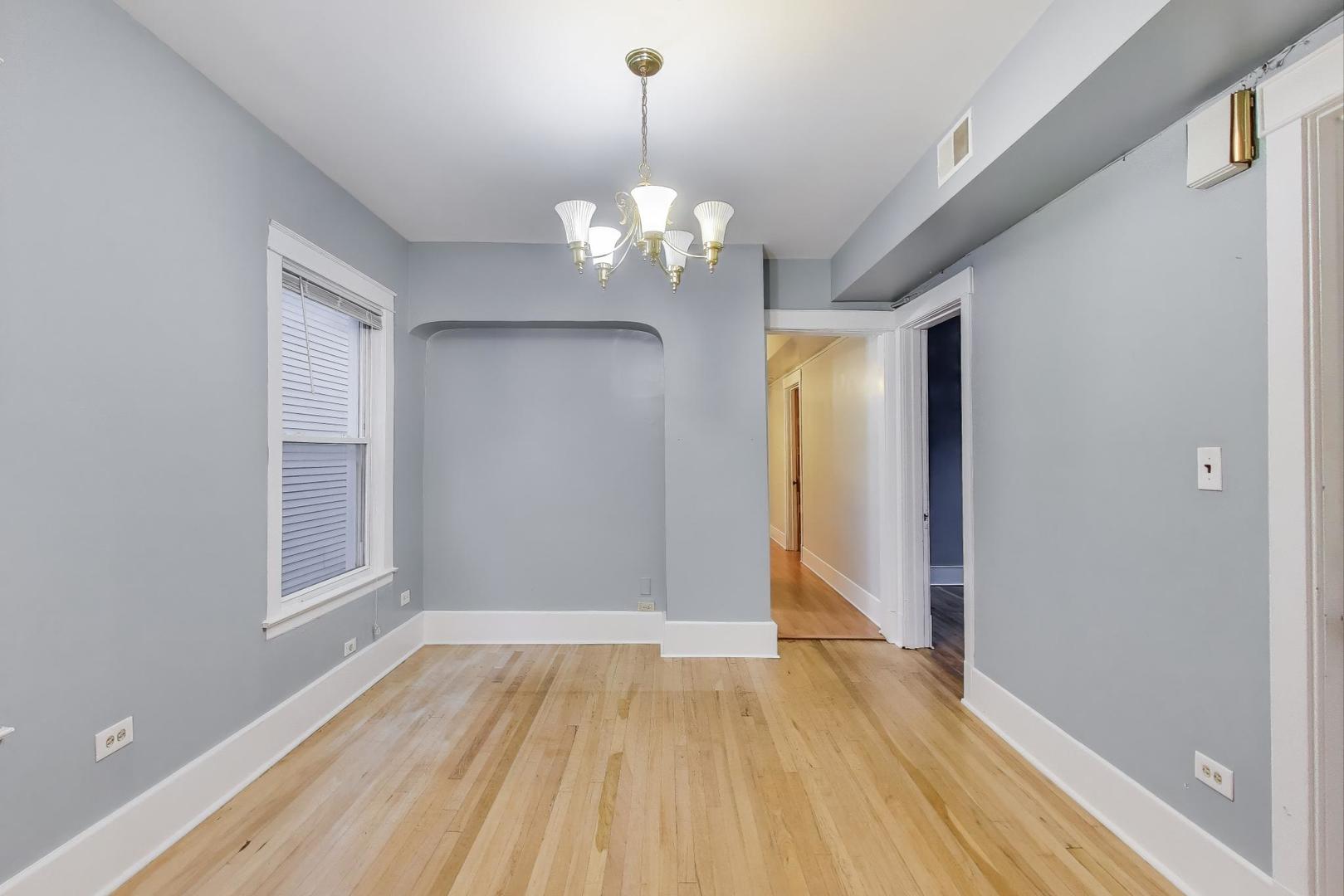 4154 North Campbell Avenue Chicago, IL 60618 - Photo 15 of 28 a view of an empty room with a window and wooden floor