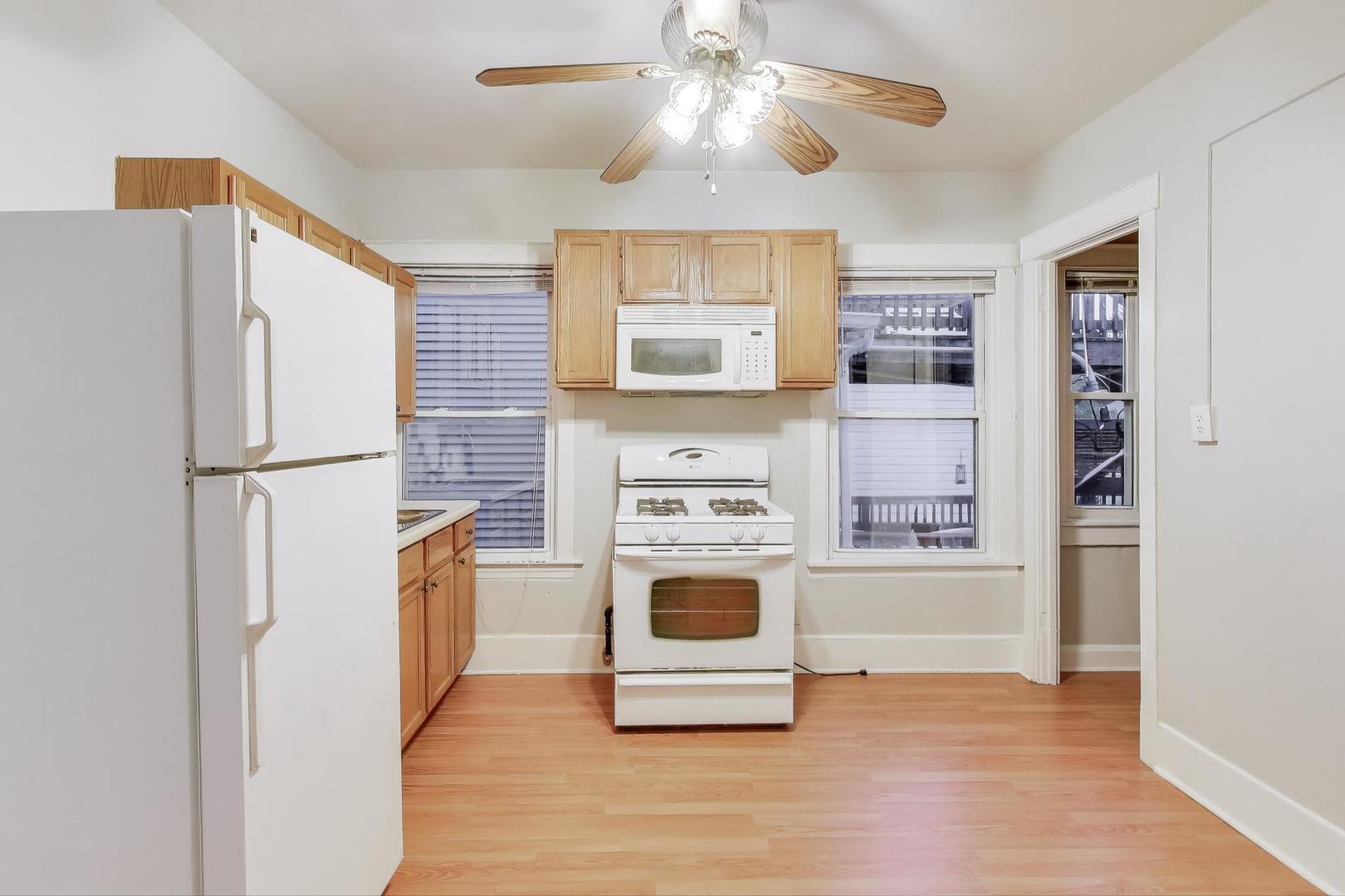 4154 North Campbell Avenue Chicago, IL 60618 - Photo 16 of 28 a kitchen with stainless steel appliances granite countertop a refrigerator a stove a sink and a microwave