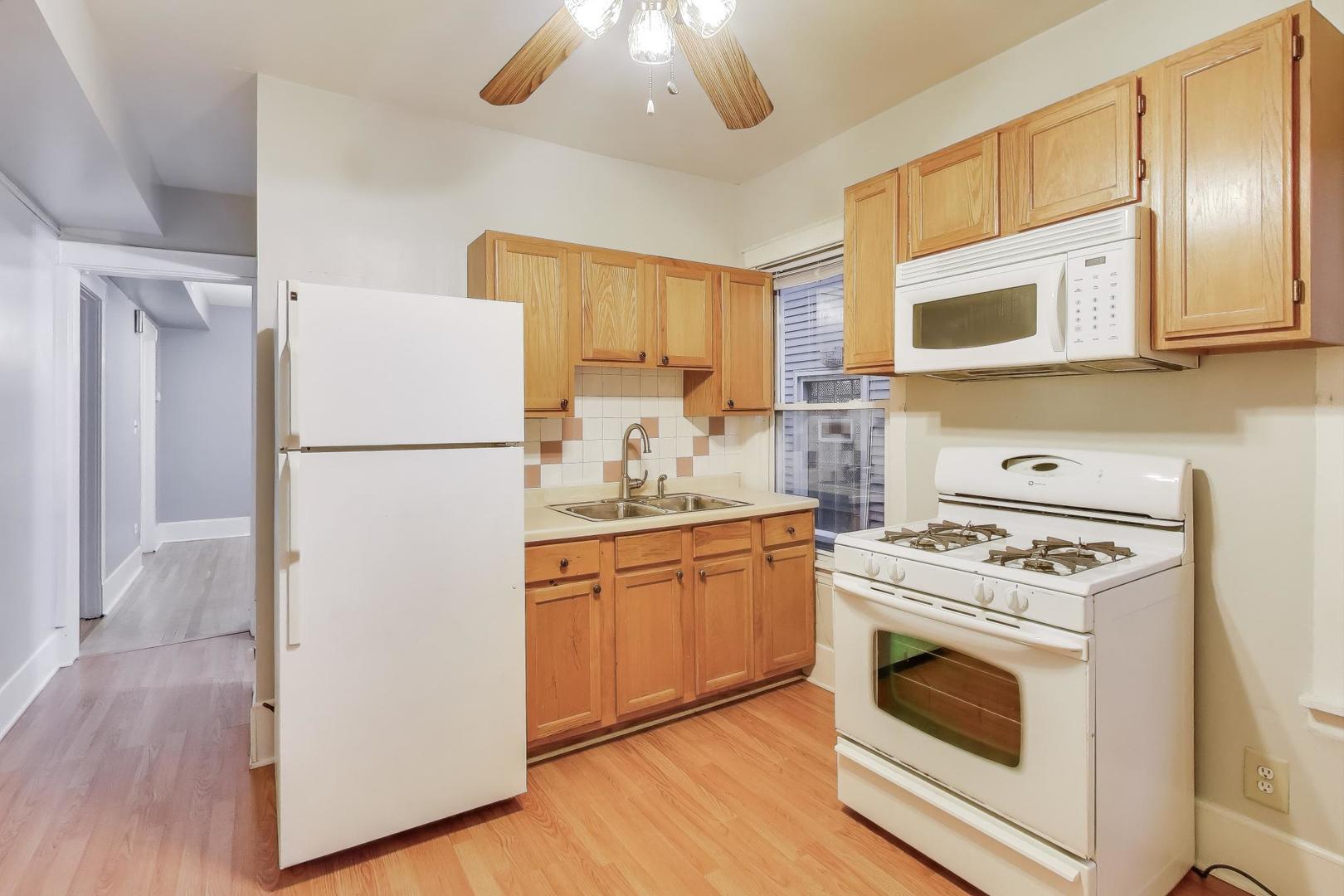4154 North Campbell Avenue Chicago, IL 60618 - Photo 17 of 28 a kitchen with a refrigerator stove and sink