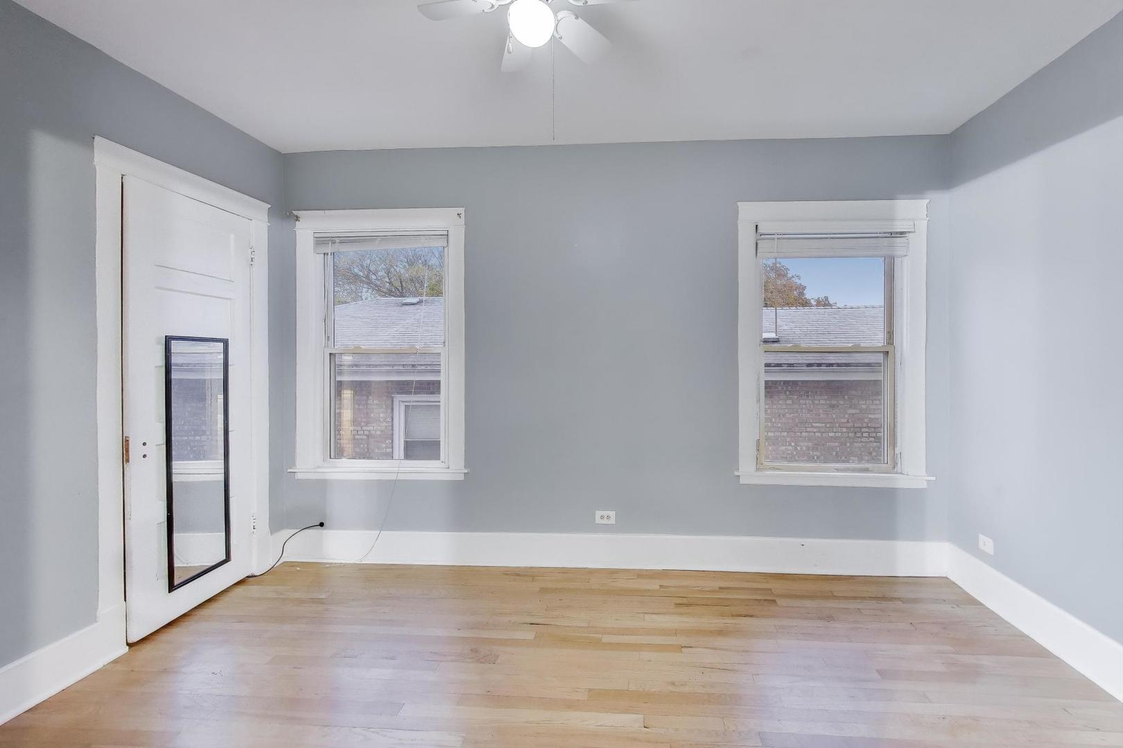 4154 North Campbell Avenue Chicago, IL 60618 - Photo 18 of 28 a view of an empty room with wooden floor and a window