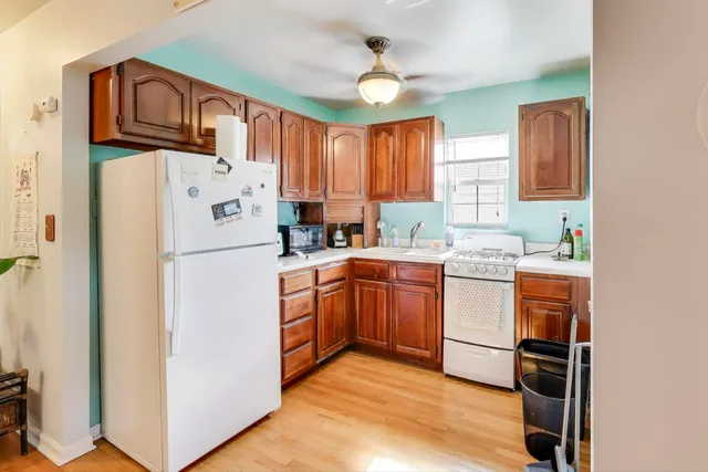 a bathroom with a sink a toilet a mirror and shower curtain