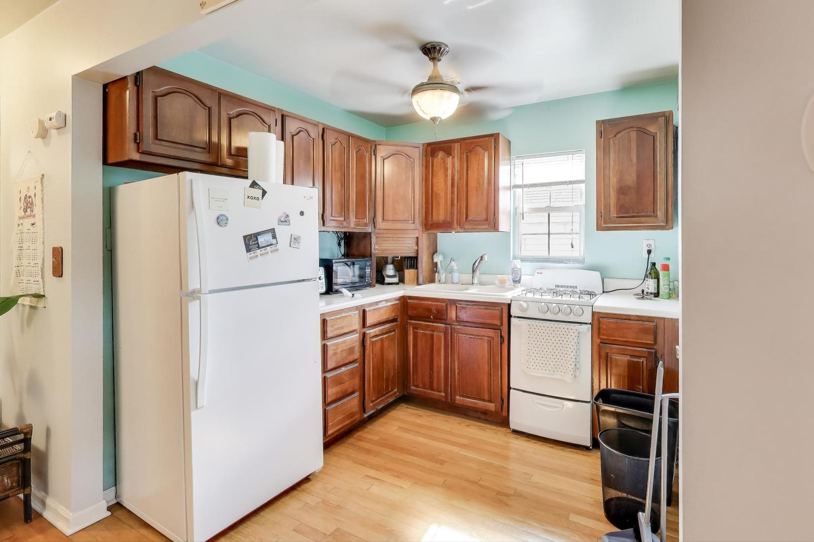 4154 North Campbell Avenue Chicago, IL 60618 - Photo 22 of 28 a kitchen with refrigerator cabinets and window