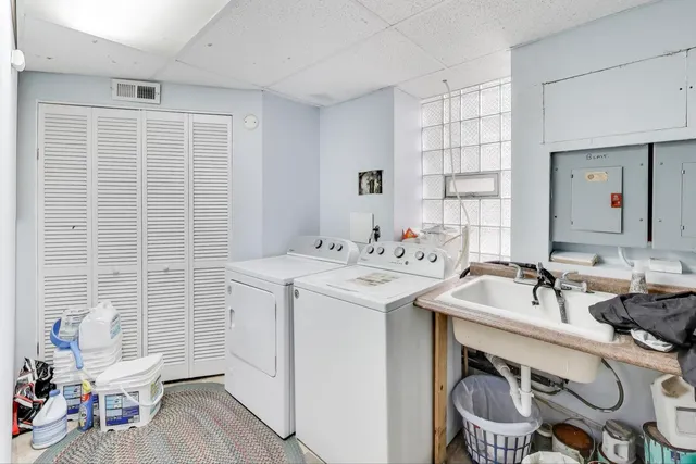 a patio with table and chairs and potted plants