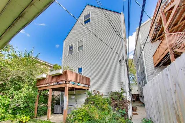 a view of backyard with table and chairs and potted plants