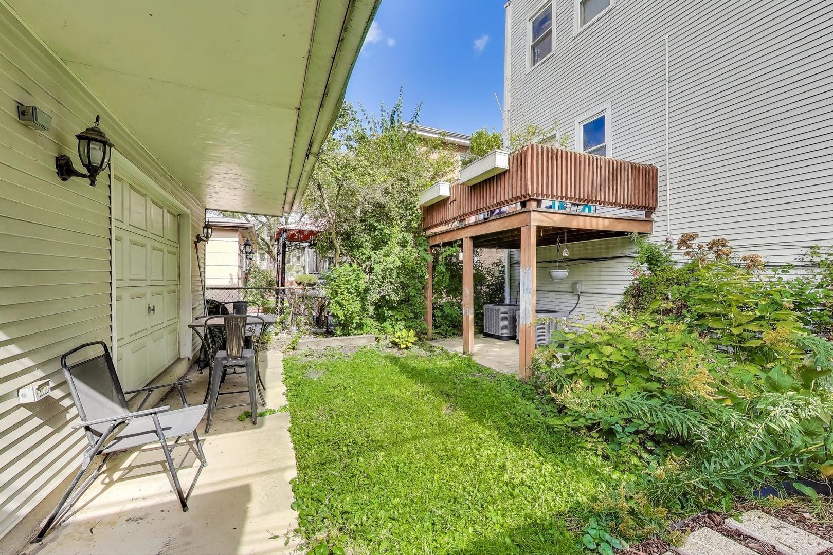 4154 North Campbell Avenue Chicago, IL 60618 - Photo 26 of 28 a view of backyard with table and chairs and potted plants