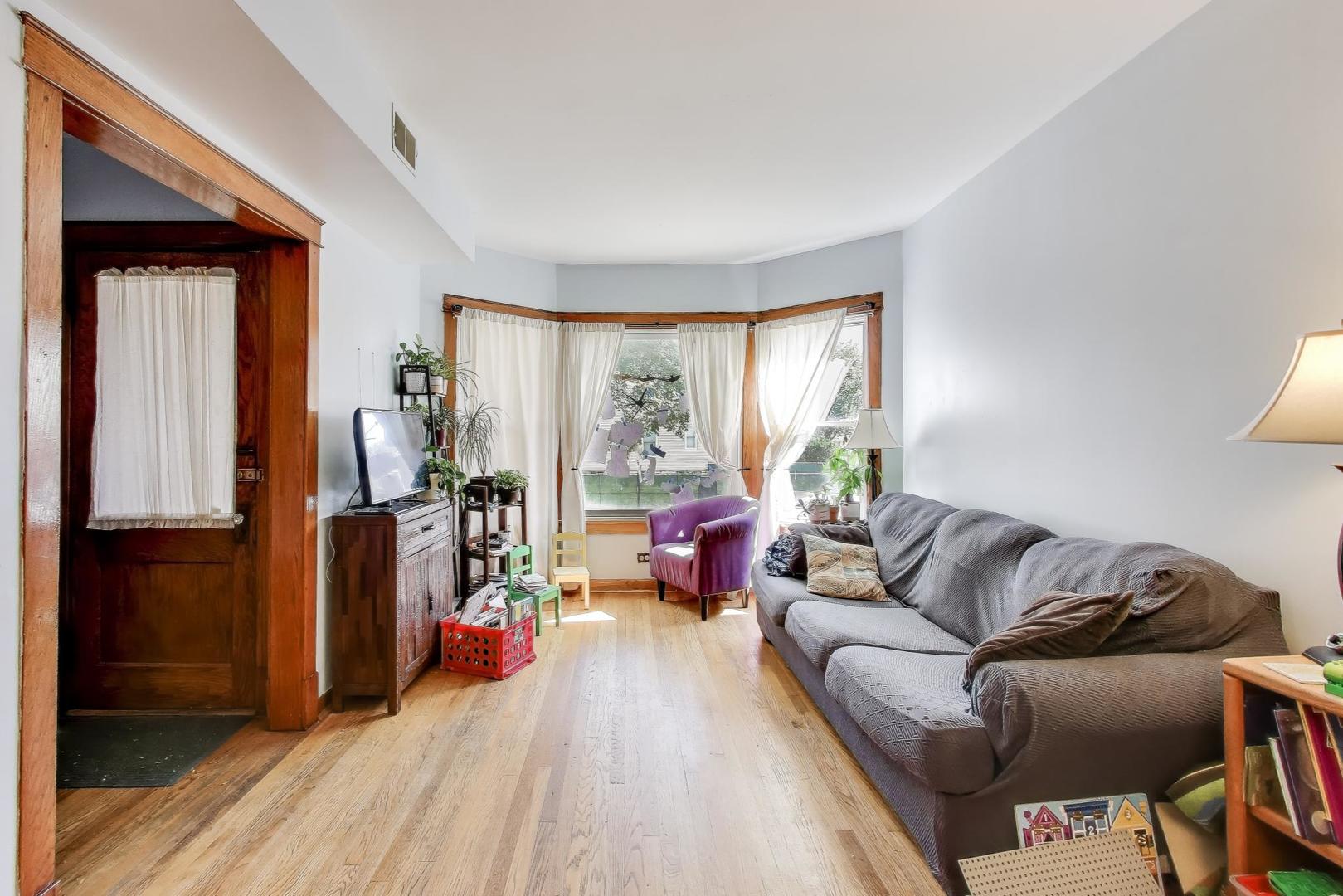 4154 North Campbell Avenue Chicago, IL 60618 - Photo 4 of 28 a living room with furniture and a large window