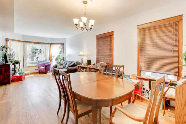 a view of a kitchen and a dining table with chairs