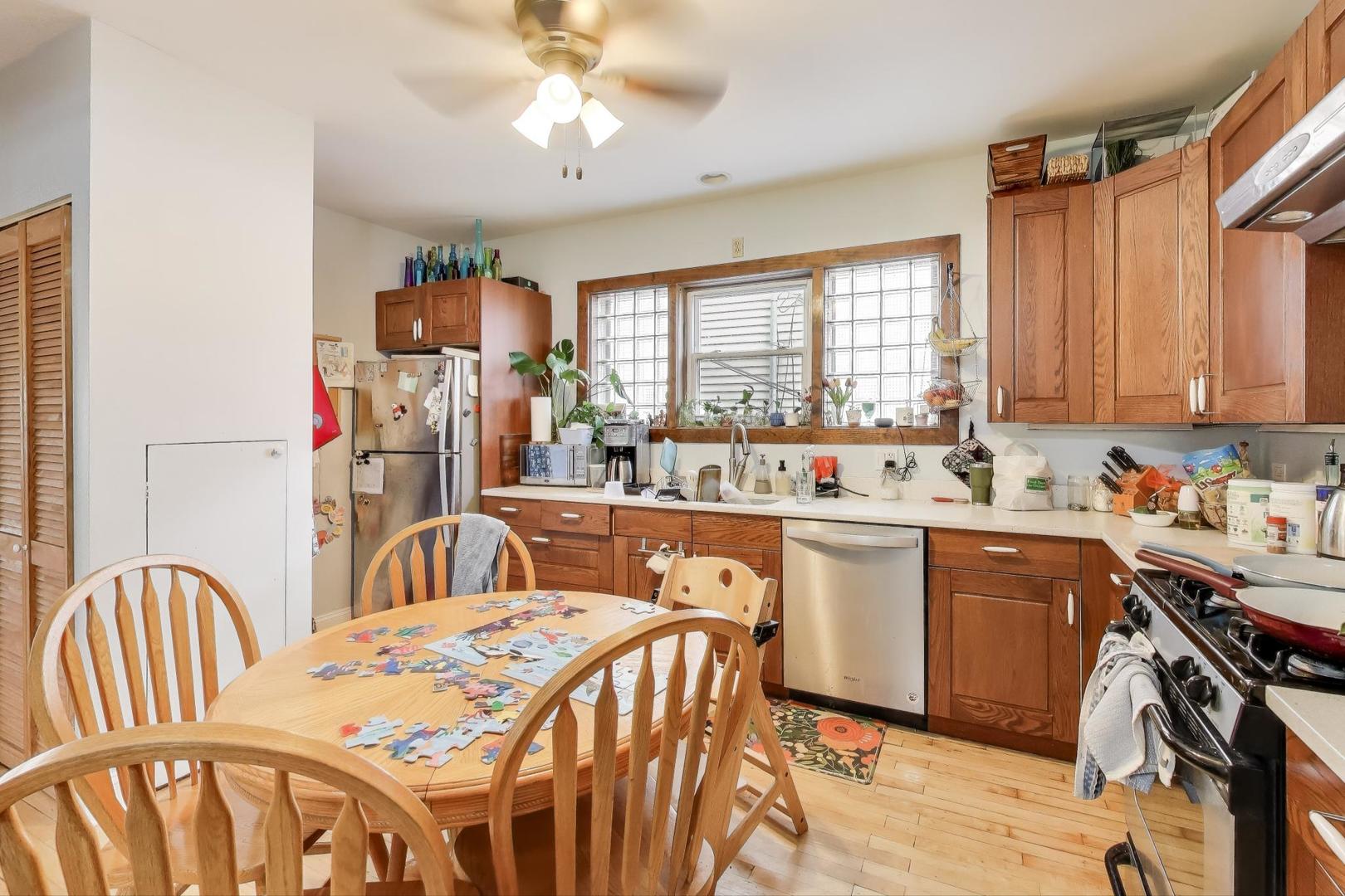 4154 North Campbell Avenue Chicago, IL 60618 - Photo 6 of 28 a view of a kitchen and a dining table with chairs