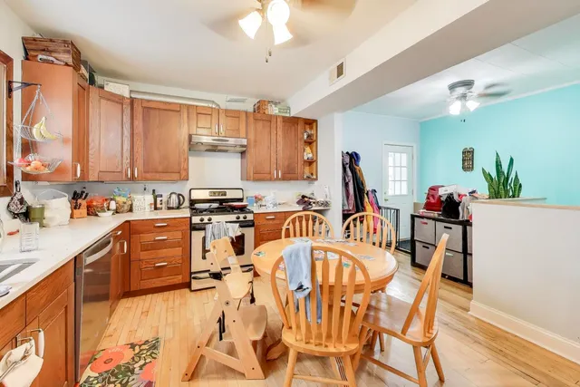a bedroom with a bed and a lamp on the dresser