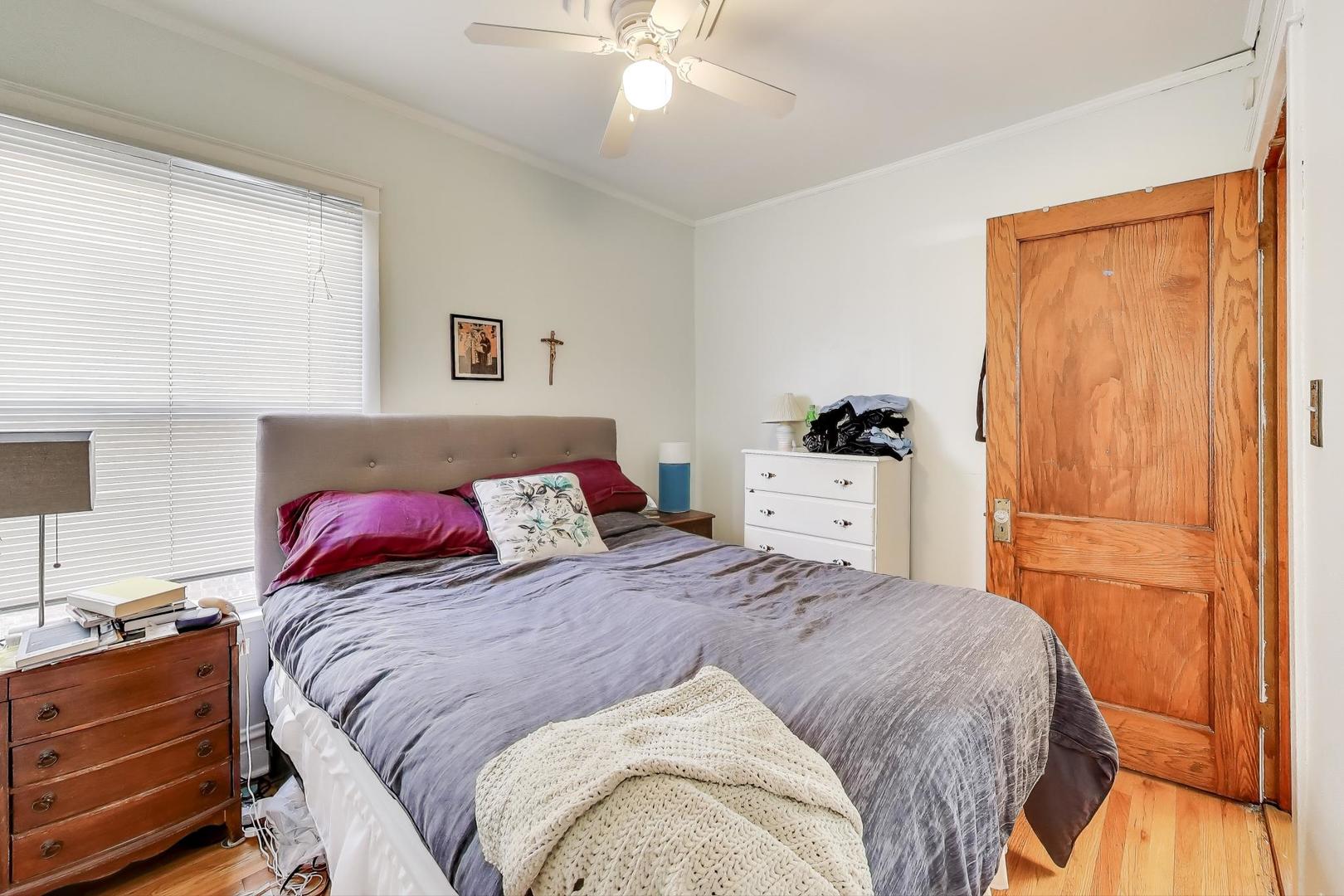 4154 North Campbell Avenue Chicago, IL 60618 - Photo 8 of 28 a bedroom with a bed and a lamp on the dresser