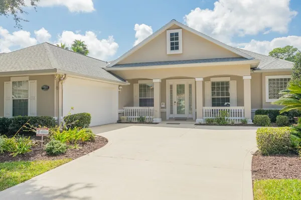 a view of a livingroom with furniture staircase and a kitchen view