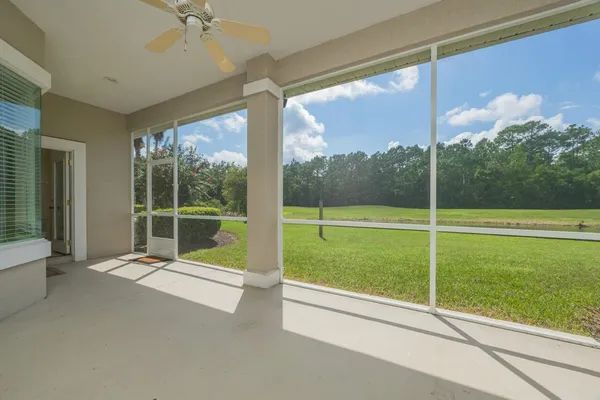 a view of empty room with fireplace and fan