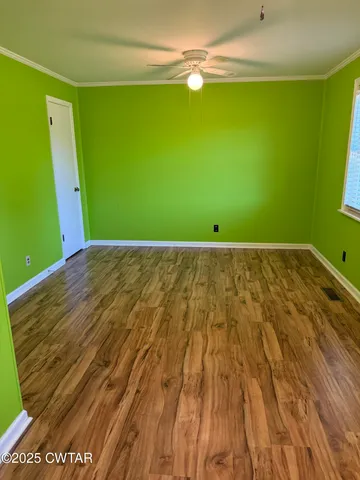 a view of a room with wooden floor