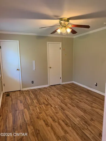 a view of a room with wooden floor and chandelier