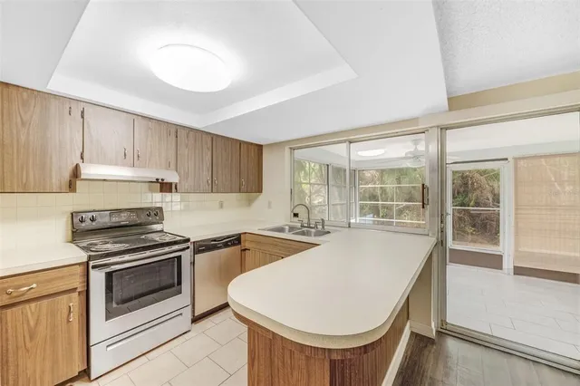 a kitchen with a stove a sink and a refrigerator