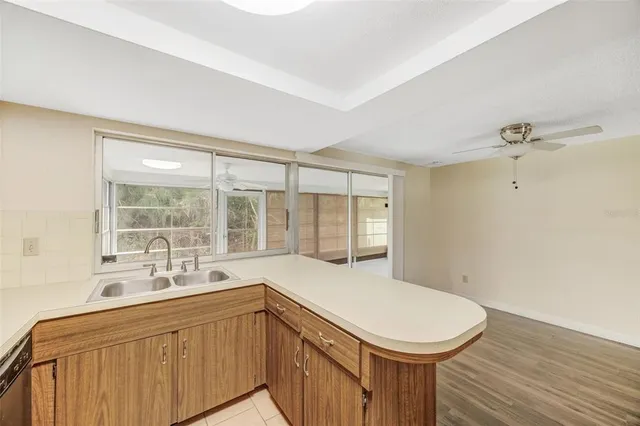 a bathroom with a sink a toilet and windows