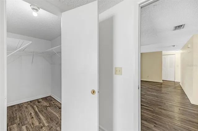 a view of hallway with wooden floor