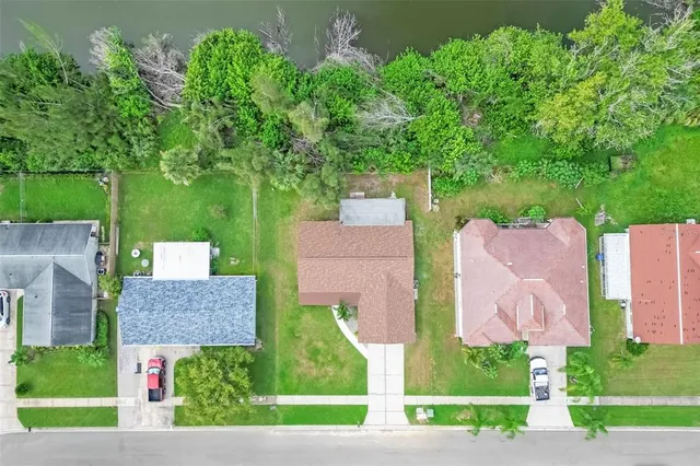 an aerial view of a house with outdoor space pool seating area and yard