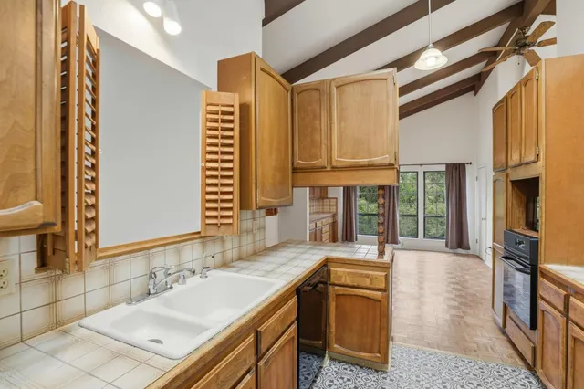 a view of a room with a window and furniture
