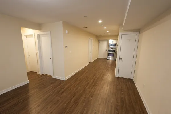 a view of a hallway with wooden floor