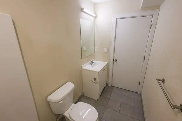 a white toilet sitting next to a bathroom sink