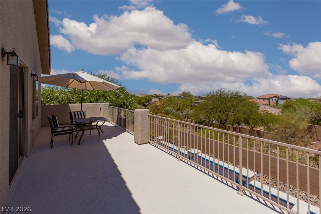 22 Douglas Grove Road Henderson, NV 89052 - Photo 49 of 72 Enjoy leisurely outdoor moments on this expansive patio, offering panoramic neighborhood vistas.