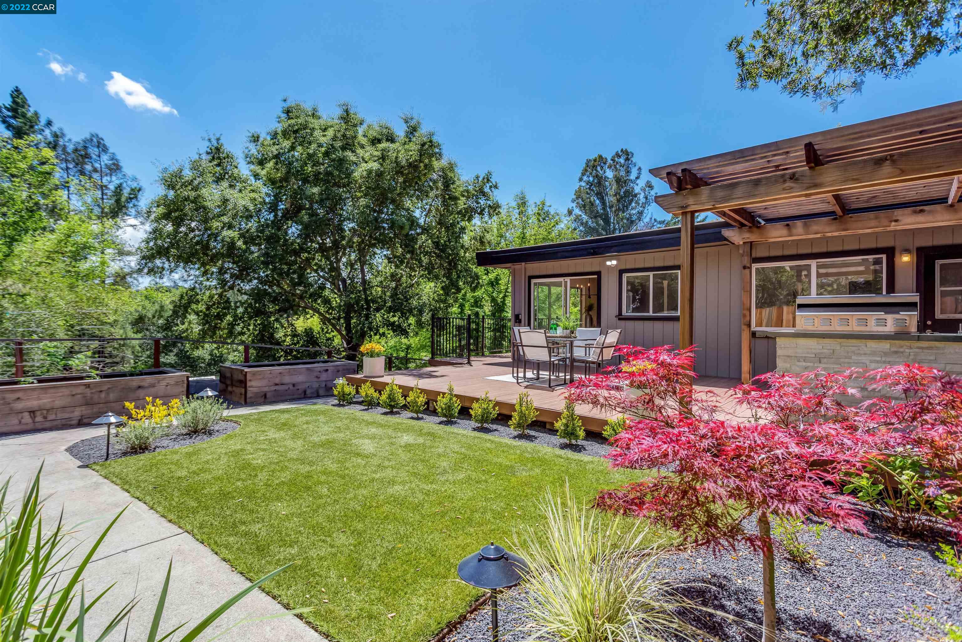a front view of house with yard and outdoor seating