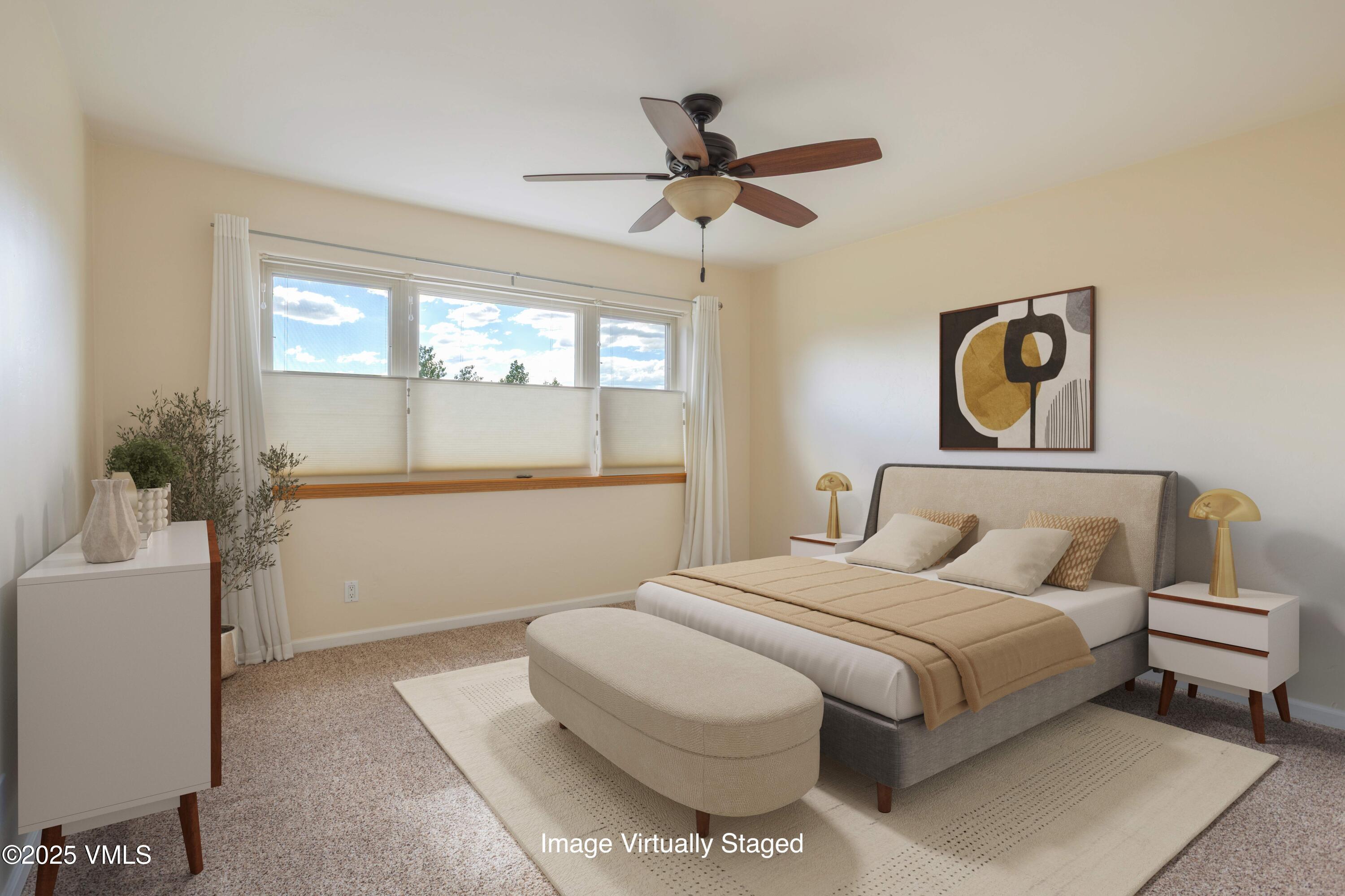 60 Mill Road, Unit J1 Eagle, CO 81631 - Photo 14 of 31 a bedroom with a bed and a chandelier