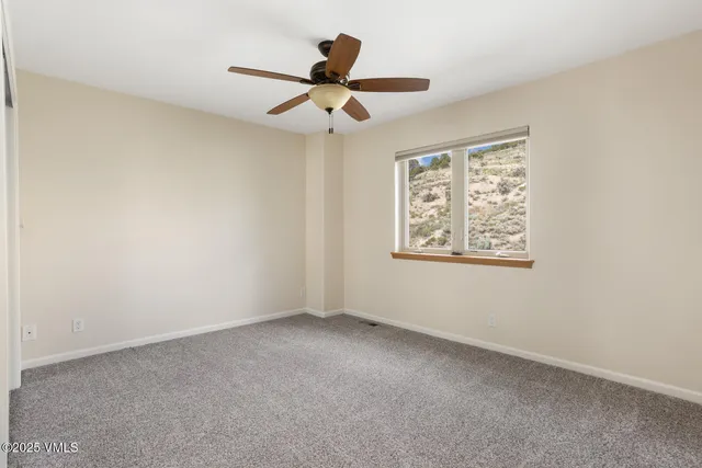 a view of room with ceiling fan and window