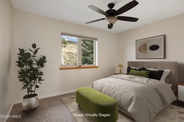 a bedroom with a bed and a potted plant