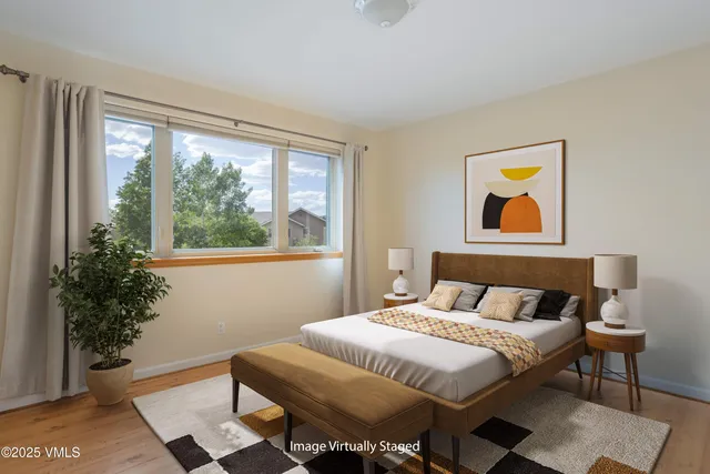 a bedroom with a bed and a painting on the wall