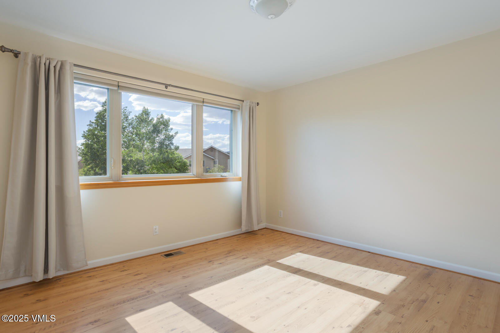 60 Mill Road, Unit J1 Eagle, CO 81631 - Photo 23 of 31 an empty room with wooden floor and windows